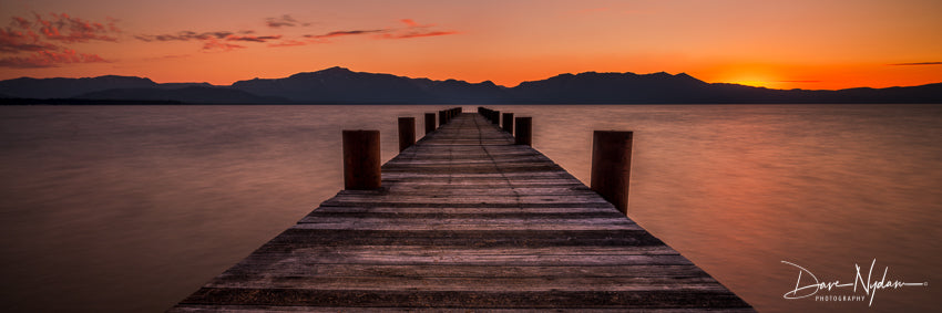 Pier with orange sunset at Lake Tahoe